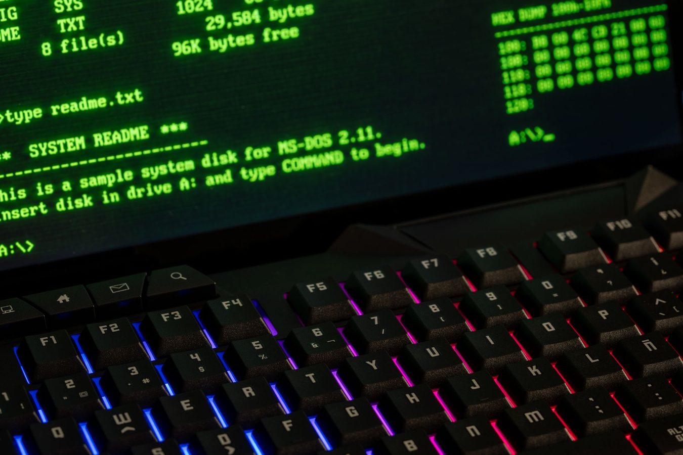 A laptop on a desk showing a terminal window with command-line text