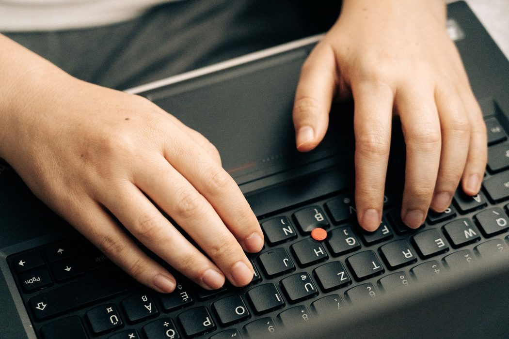 A person typing commands into a laptop terminal window
